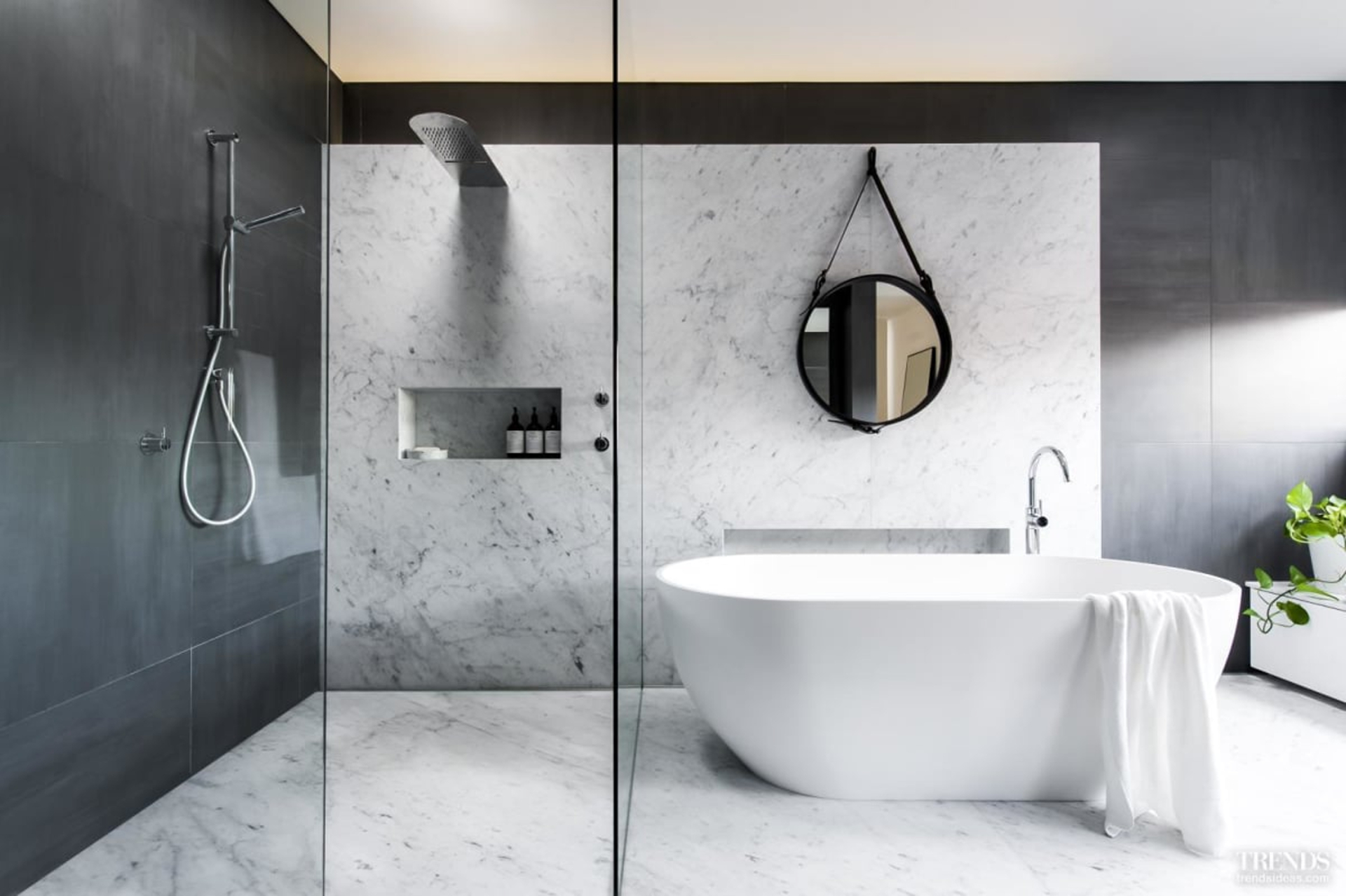 Luxury surfaces, subtle layered lighting with dimmers and a floating shower and bath plinth come together to dramatic effect in this two-toned master ensuite by designer Darren Genner of Minosa.